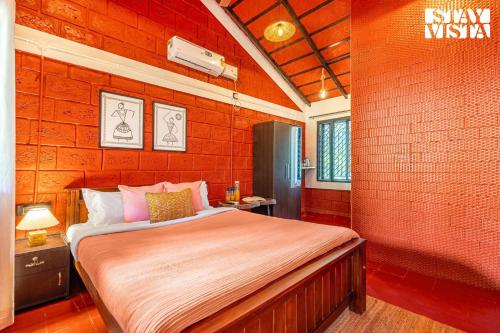 a bedroom with a large bed in a brick wall at 4BR Vatika Nature Nest - Mirjan - Gokarna - Hike, Pray, Play in Gokarna