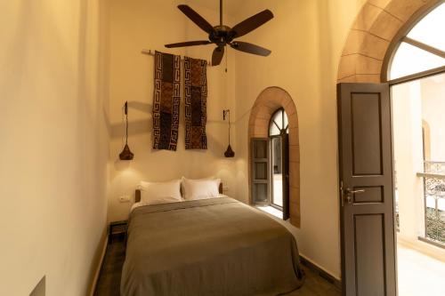 a bedroom with a bed and a ceiling fan at Maison 250 - Adult Only in Essaouira