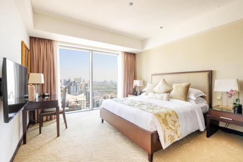 a bedroom with a large bed and a large window at Emaar Dubai Marina Residences - formerly Address Dubai Marina in Dubai