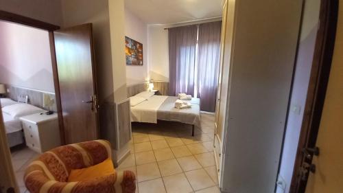 a small room with a bed and a room with a bathroom at Hotel Le 3 Fonti in Loro Ciuffenna