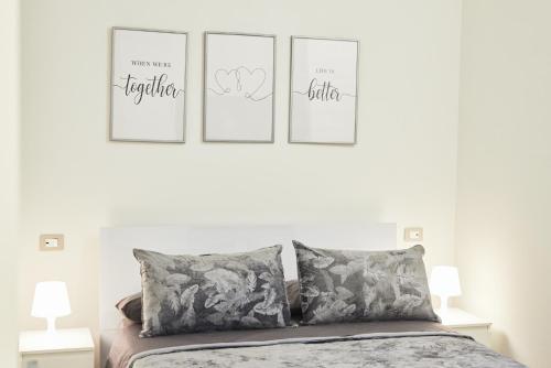 a bedroom with four pictures on the wall above a bed at Luxury Dream Rooms in Cava deʼ Tirreni