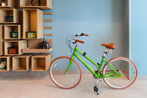 a green bike parked in a room with wooden shelves at Element Albuquerque Uptown in Albuquerque