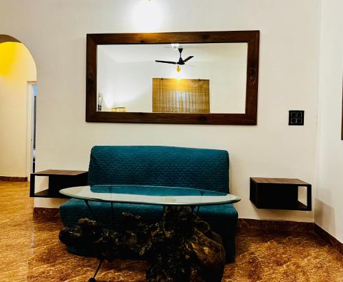a table and a chair in a room with a mirror at Janice Villa Arambol in Arambol
