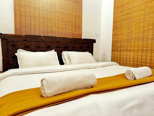 two beds with towels sitting on top of them at Janice Villa Arambol in Arambol