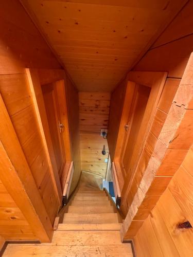 an overhead view of a wooden room with wooden stairs at Chalet Berken in Ernen