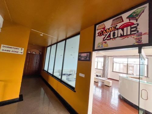 a room with a game zone sign on the wall at Ananya Comfortss in Hospet