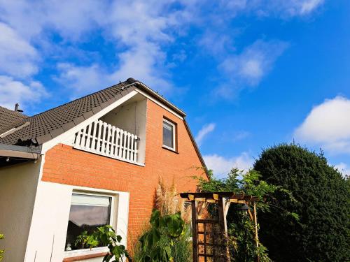 a brick house with a blue sky in the background at Ferienwohnung "Weit Blick" Objekt-ID 15678-6 in Neu Schloen