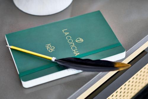 a pen sitting on top of a book on a table at La Concha Key West, Autograph Collection in Key West