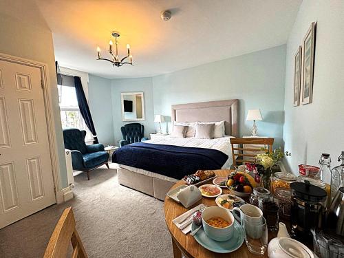 a bedroom with a bed and a table with food on it at Abbey View House in Youghal