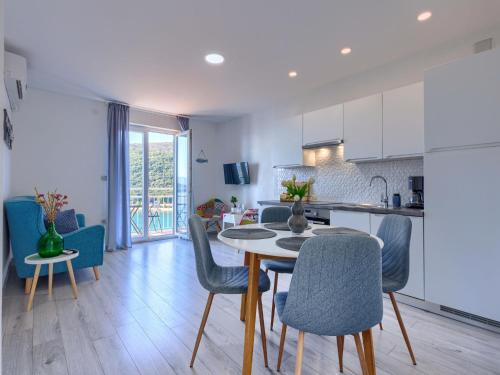 a kitchen and dining room with a table and chairs at Apartment Boris by Interhome in Raša