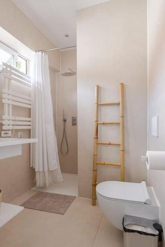 a white bathroom with a toilet and a shower at Family Villa in Lisbon ,Heated Pool ,Elevator,Parking,6 Bedrooms,Sleeps 14 in Lisbon
