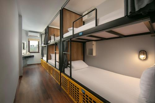 a room with three bunk beds in a hostel at Lakeview Backpackers Hostel & Rooftop Bar in Hanoi
