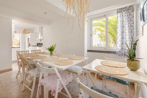 a white dining room with tables and chairs at Lx Villa -10m to downtown up to14 ppl,heatable pool and lift in Lisbon