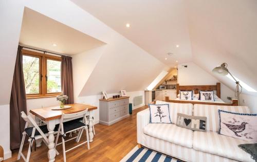 a living room with a couch and a table at Pentland Hills Chalet in Edinburgh
