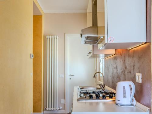 a kitchen with a sink and a stove top oven at Apartment Sole by Interhome in Claino