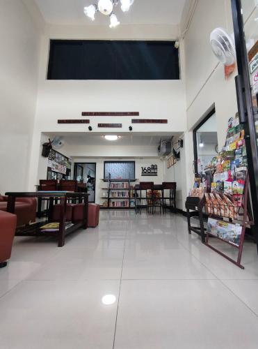 a store aisle with tables and chairs in a store at 168 Chiangmai Guesthouse in Chiang Mai