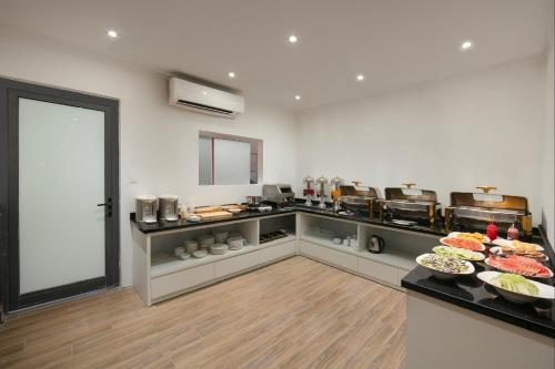 a kitchen with many plates of food on a counter at Lakeview Backpackers Hostel & Rooftop Bar in Hanoi
