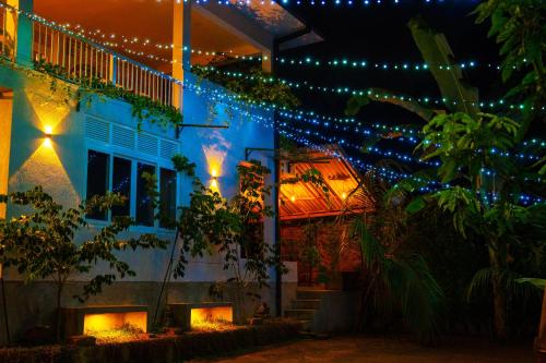 a house decorated with christmas lights at night at Pretty Villa in Gelioya