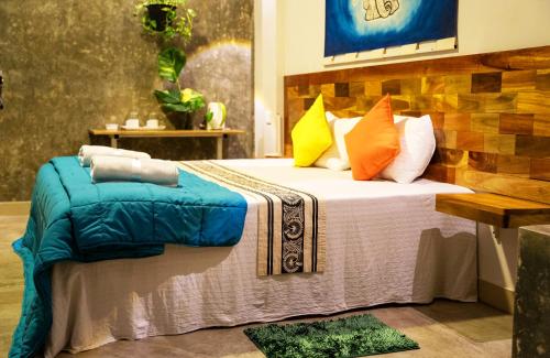 a bedroom with a bed with colorful pillows at Pretty Villa in Gelioya