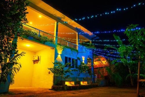 a white house with christmas lights on it at Pretty Villa in Gelioya