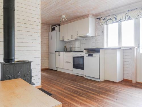 a kitchen with white appliances and a stove at Chalet Grönede by Interhome in Kisa