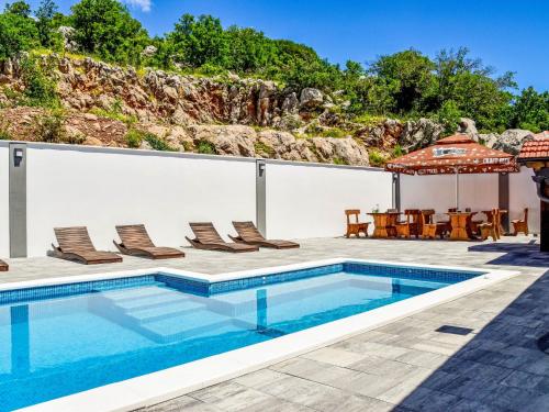 a villa with a swimming pool and a patio at Apartment Delfin-9 by Interhome in Cesarica