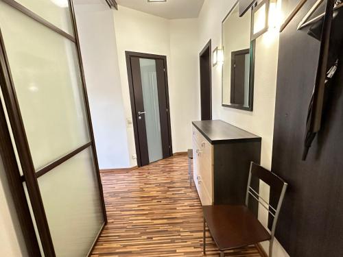 a hallway with a chair and a desk and a mirror at Апартаменты на Бассейной in Kyiv