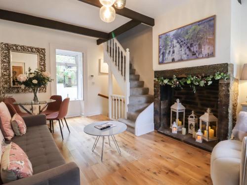 a living room with a couch and a fireplace at The Snug on the Cobbles in Keighley