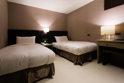 Cama o camas de una habitación en Chiayi Oriental Pearl International Hotel
