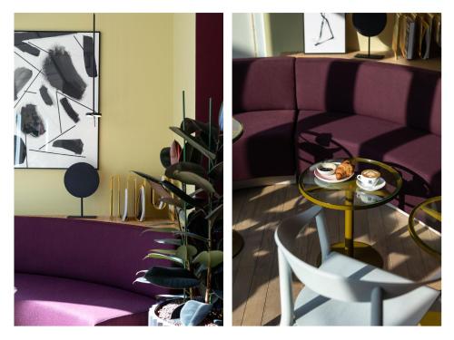 a living room with a purple couch and a table at Conscious Hotel Museum Square in Amsterdam