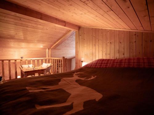 a bedroom with a bed in a wooden cabin at Chalet Chalet Lorila by Interhome in Villars-sur-Ollon