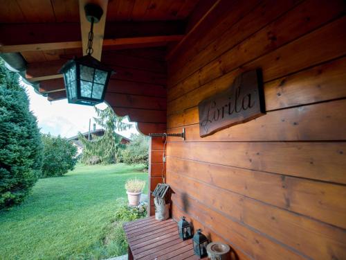 a wooden cabin with a sign on the side of it at Chalet Chalet Lorila by Interhome in Villars-sur-Ollon