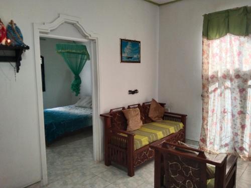 a living room with a couch and a bed at Diana's place in Negombo