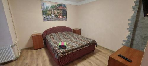 a bedroom with a bed and a painting on the wall at Hotel Desna KUT in Kyiv