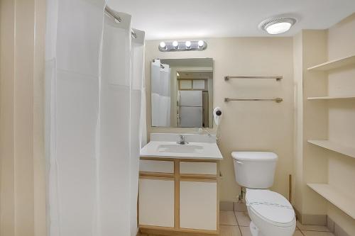 a bathroom with a white toilet and a sink at Bay Watch Resort | Oceanfront | King Suite | Budget Friendly in Myrtle Beach