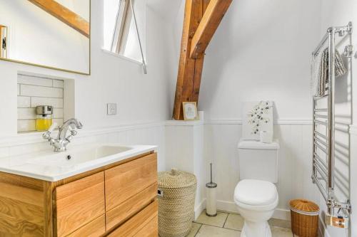 a white bathroom with a toilet and a sink at Beautiful French Villa, Sleeps 8, Private Pool & Starlink WIFI in Bourdeilles