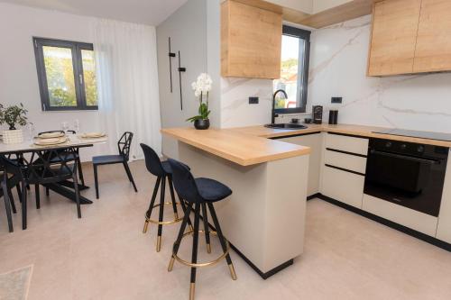 a kitchen and dining room with a table and chairs at Villa Barovic - Delux Apartment in Mlini