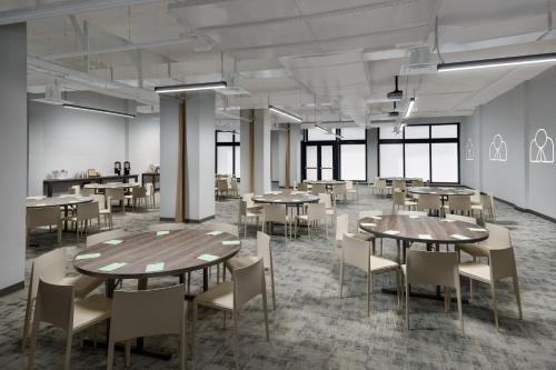 a large room with tables and chairs and windows at The Goodtime Hotel, Miami Beach a Tribute Portfolio Hotel in Miami Beach