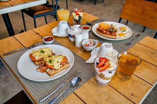 a table with two plates of breakfast food and drinks at 9 On Barrack in Cape Town