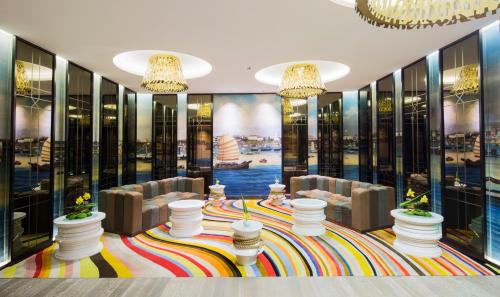a lobby with chairs and tables and windows at LN Hotel Five in Guangzhou