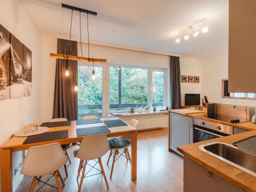 a kitchen with a table and chairs and a large window at Apartment Monte Grau Top 5 by Interhome in Bad Gastein
