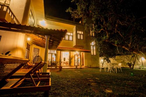 an exterior view of a house at night at Nibbana Mirissa Hotel in Mirissa