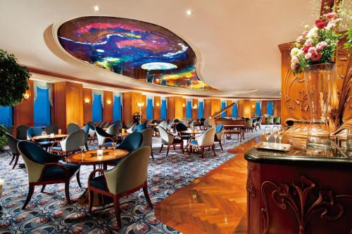a restaurant with tables and chairs and a colorful ceiling at Nagoya Marriott Associa Hotel in Nagoya