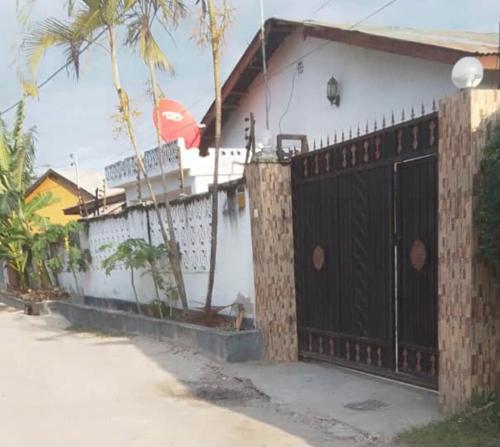 a house with a black gate and a fence at Gillian's Place - 3 Bedrooms in Dar es Salaam