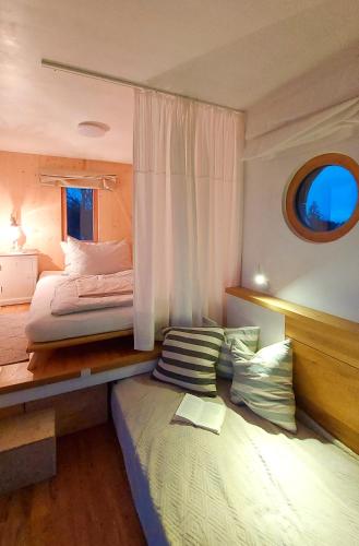 a bedroom with a large bed and a window at Tiny Haus "Mrs Green" - Boutique Loft Nina&Susanne in Drosendorf Stadt