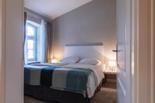 a bedroom with a bed with two pillows and a window at Ferienhaus Annabelle in Crivitz
