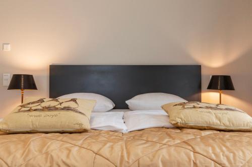 a bed with two pillows on top of it at Ferienhaus Annabelle in Crivitz