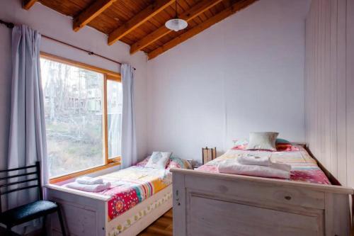 Ένα ή περισσότερα κρεβάτια σε δωμάτιο στο Cálida casa en el fin del mundo