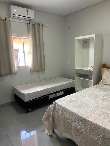 a bedroom with a bed and a window and a mattress at Casa de temporadas Simone/ Rafael in Carolina
