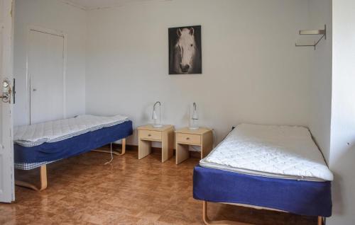 a room with two beds and two night stands at 1 Bedroom Nice Home In Tomelilla in Tomelilla